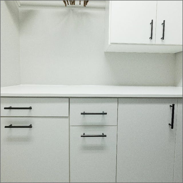 white counters with stainless steel appliance