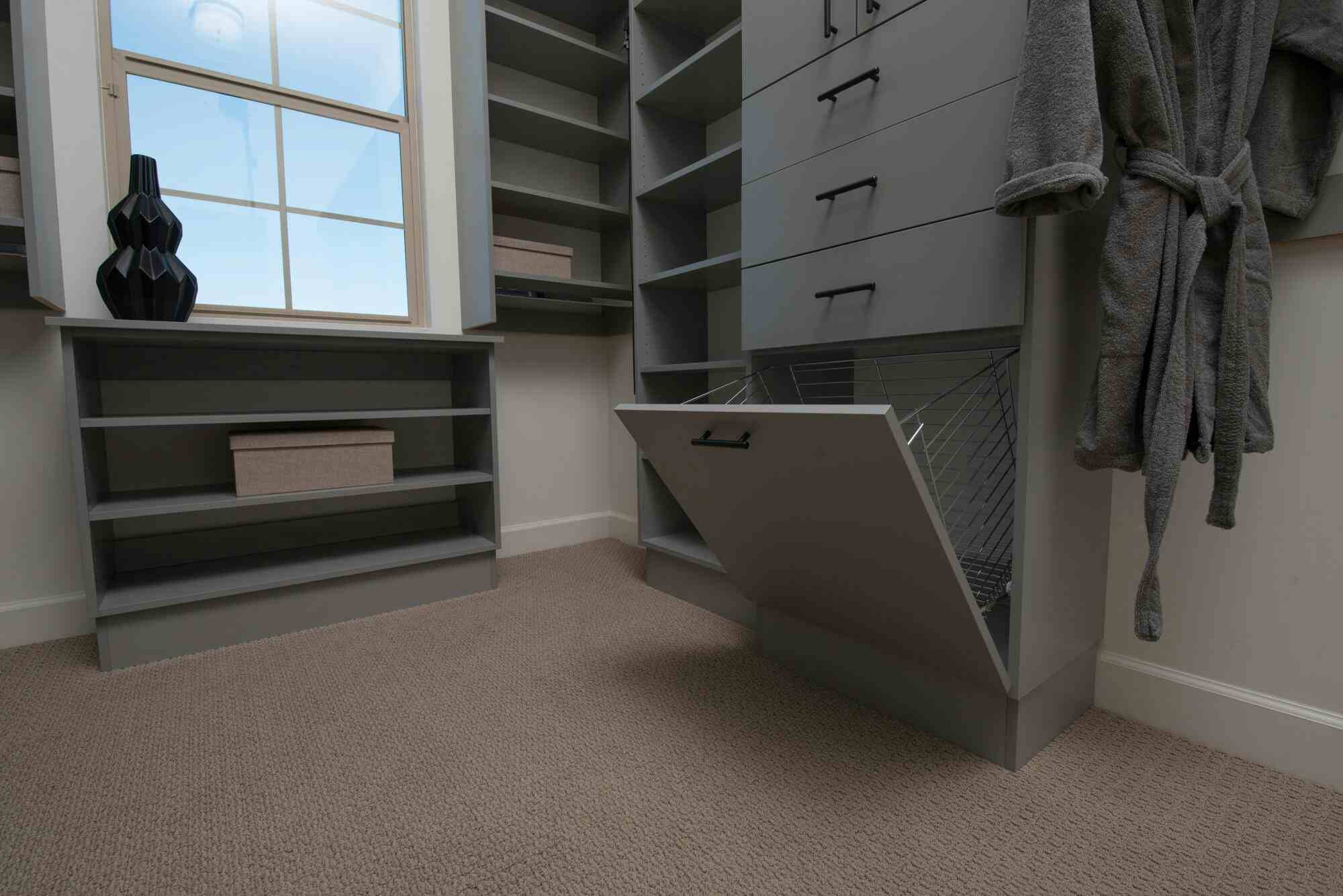 walk-in gray closet with pull-out cabinets