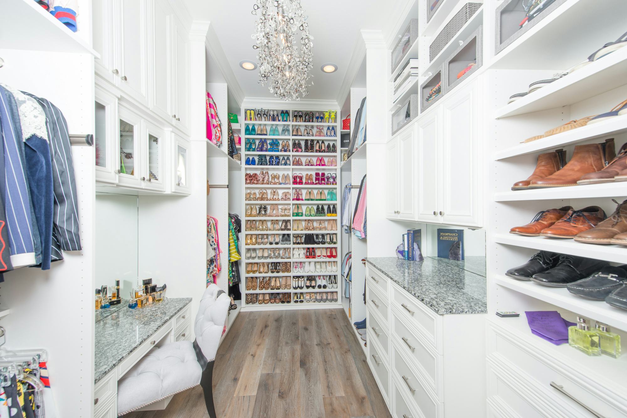 white luxury closet with shoe rack and vanity area