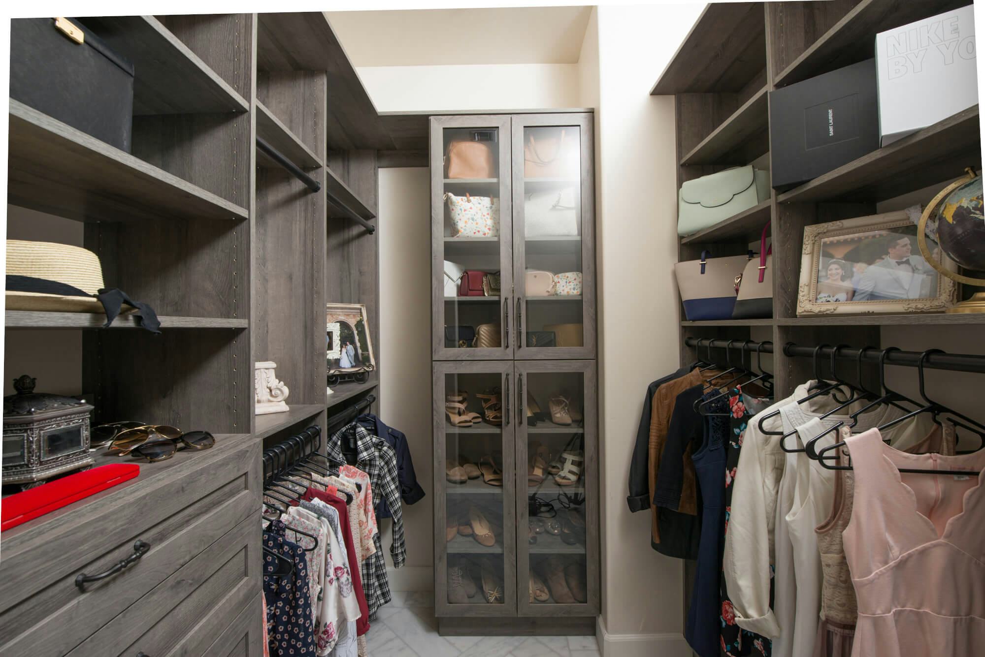 walk-in closet with middle glass show rack